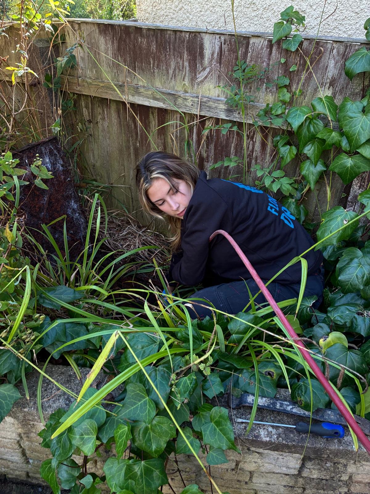 Flow Sure Drains engineer feeding a CCTV camera into a drain inspection chamber in Bristol